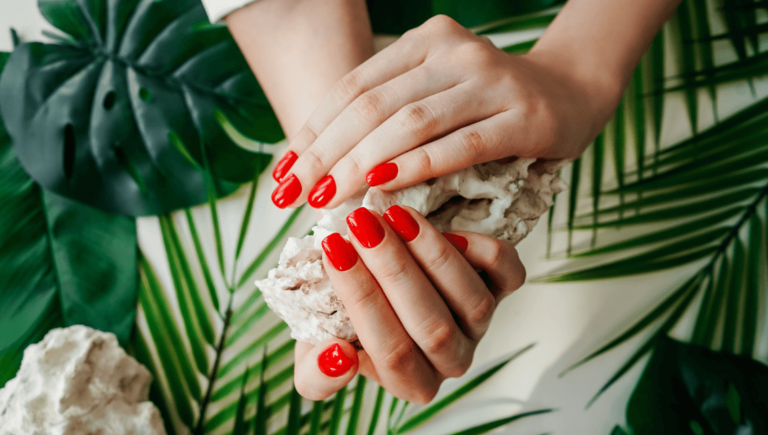 A Woman'S Hands With Red Painted Nails Holding A Rock Https://Onemorestarmedia.com