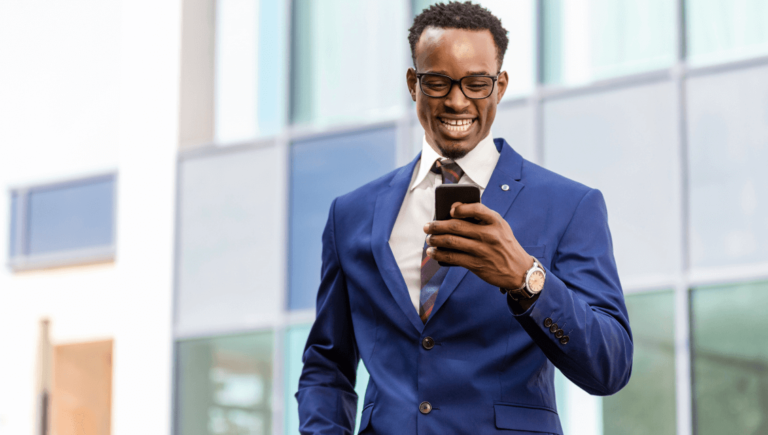 St. Louis Insurance Agent In A Suit Looking At A Phone Https://Onemorestarmedia.com