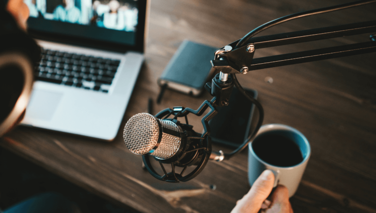 A Microphone And A Cup Of Coffee During Content Creation Www.onemorestarmedia.com