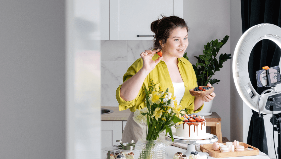 A Female Cake Shop Owner Owner Creating Video Content Holding Berries Let'S Chat Www.onemorestarmedia.com
